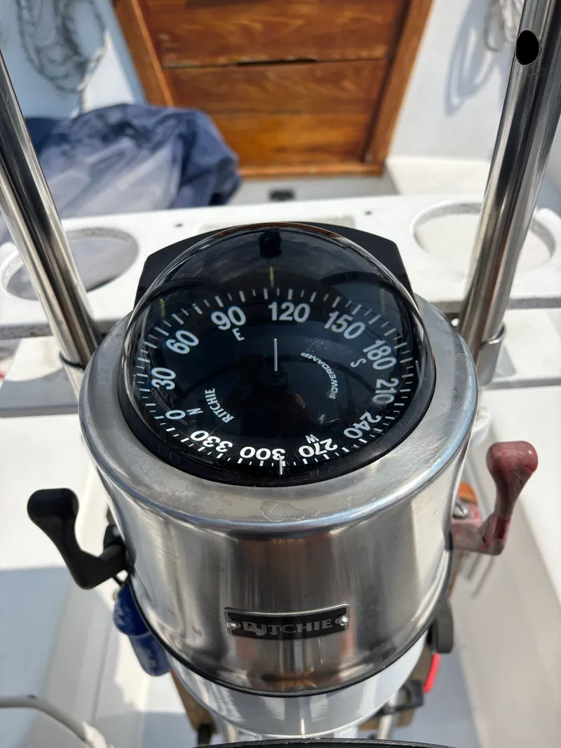Slide: The Image of Compass on a 1992 Catalina 34 sailboat, showing navigation directions. - 27