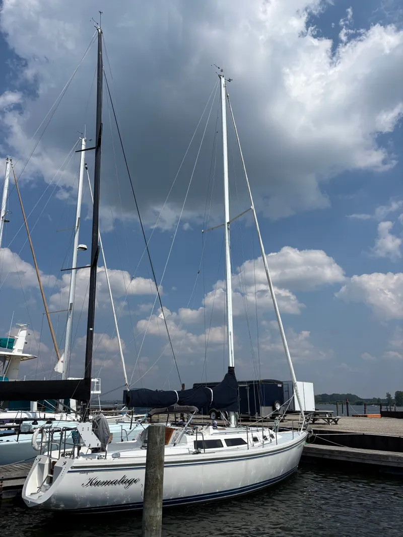 Slide: The Image of Sailboat Catalina 34, 1992 model, docked under a partly cloudy sky. - 3
