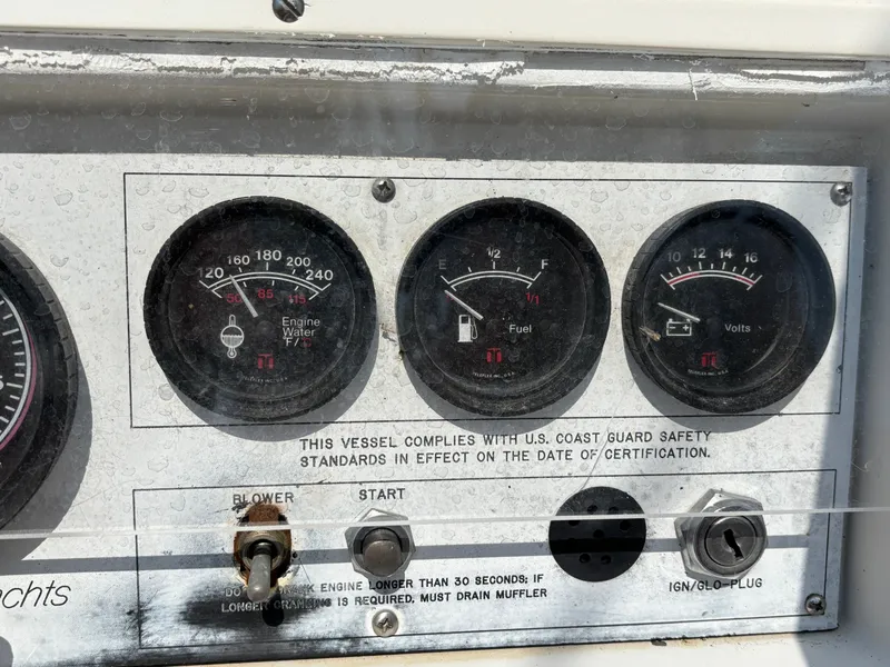Slide: The Image of Dashboard of a 1992 Catalina 34 boat with gauges and safety compliance. - 30