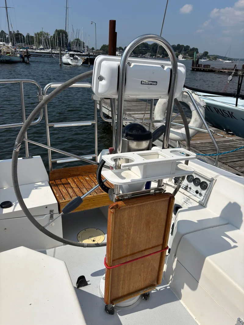 Slide: The Image of Cockpit of a 1992 Catalina 34 sailboat with steering wheel and navigation equipment. - 31