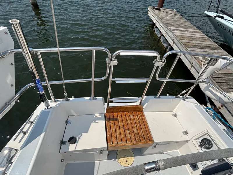 Slide: The Image of 1992 Catalina 34 sailboat stern view with wooden platform and dock in background. - 38