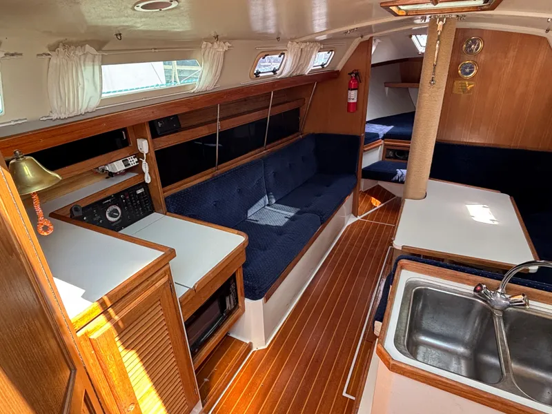 Slide: The Image of Interior of a 1992 Catalina 34 sailboat with wood finish and blue upholstery. - 45