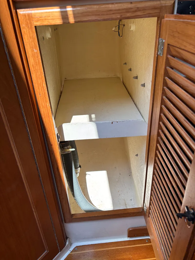 Slide: The Image of Empty wooden cabinet interior on a 1992 Catalina 34 boat. - 47