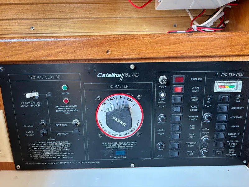 Slide: The Image of Control panel of a 1992 Catalina 34 yacht with various switches and indicators. - 48