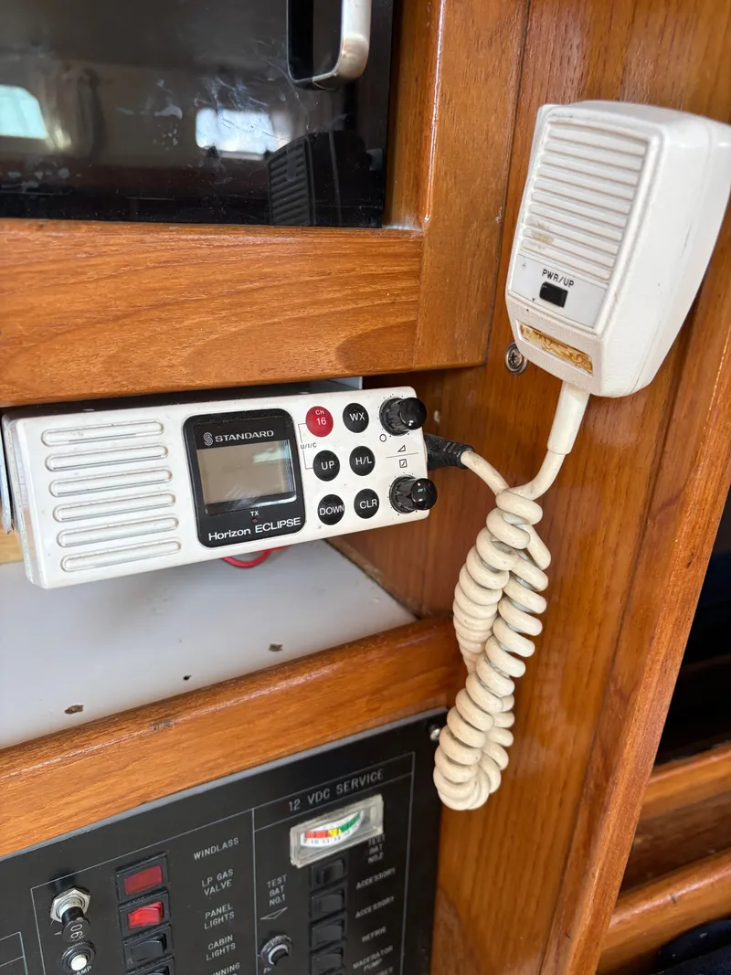 Slide: The Image of VHF radio and control panel inside a 1992 Catalina 34 sailboat cabin. - 49
