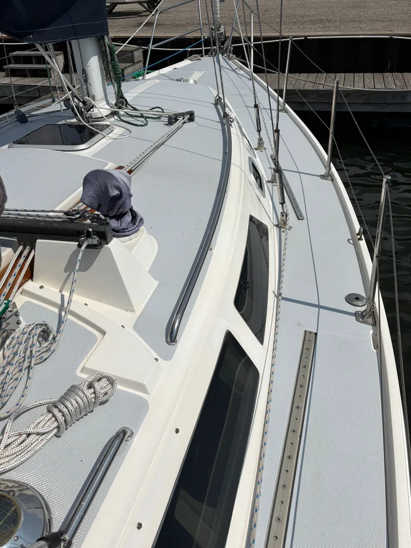 Slide: The Image of 1992 Catalina 34 sailboat deck with rigging and windows at a marina. - 7