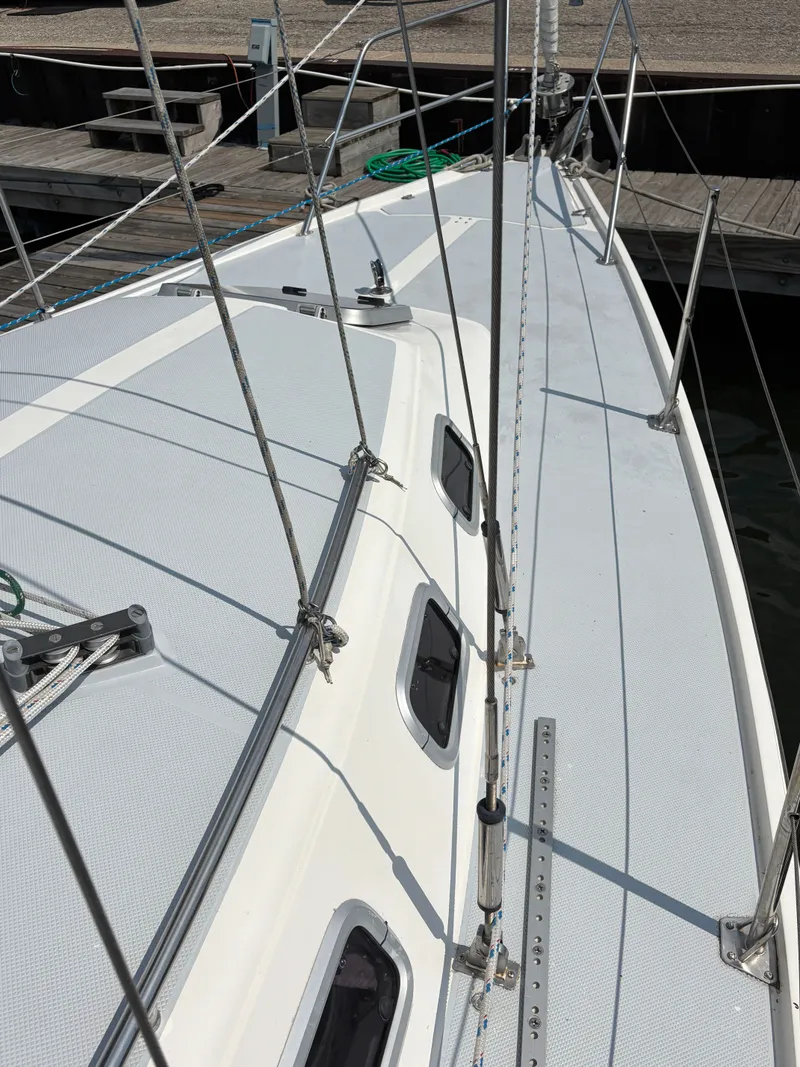 Slide: The Image of 1992 Catalina 34 sailboat deck with rigging and windows at a marina. - 8