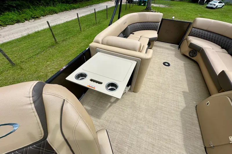 Slide: The Image of 2022 Harris FloteBote 230 Super Sunliner LX interior with beige seating and table. - 17