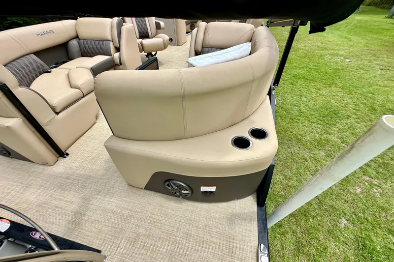 Slide: The Image of 2022 Harris FloteBote 230 Super Sunliner LX interior with beige seating and cup holders. - 18
