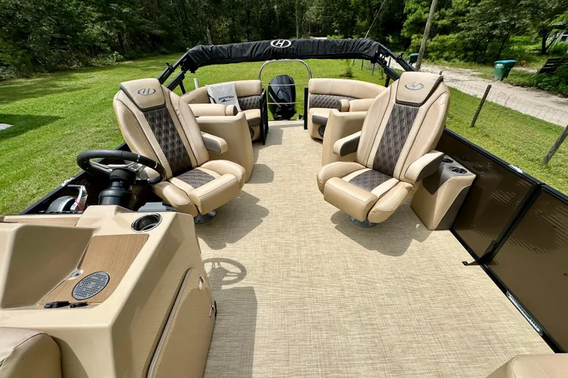 Slide: The Image of 2022 Harris FloteBote 230 Super Sunliner LX interior with luxurious seating and steering console. - 21