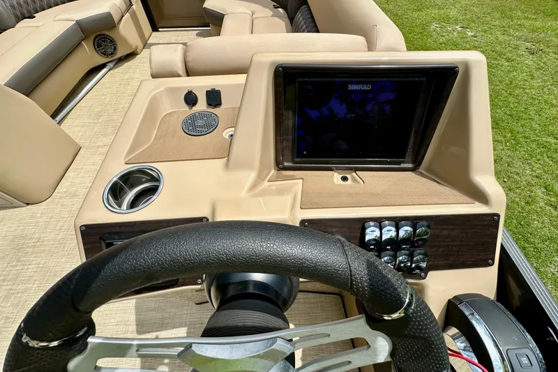 Slide: The Image of 2022 Harris FloteBote 230 Super Sunliner LX dashboard with steering wheel and control panel. - 26