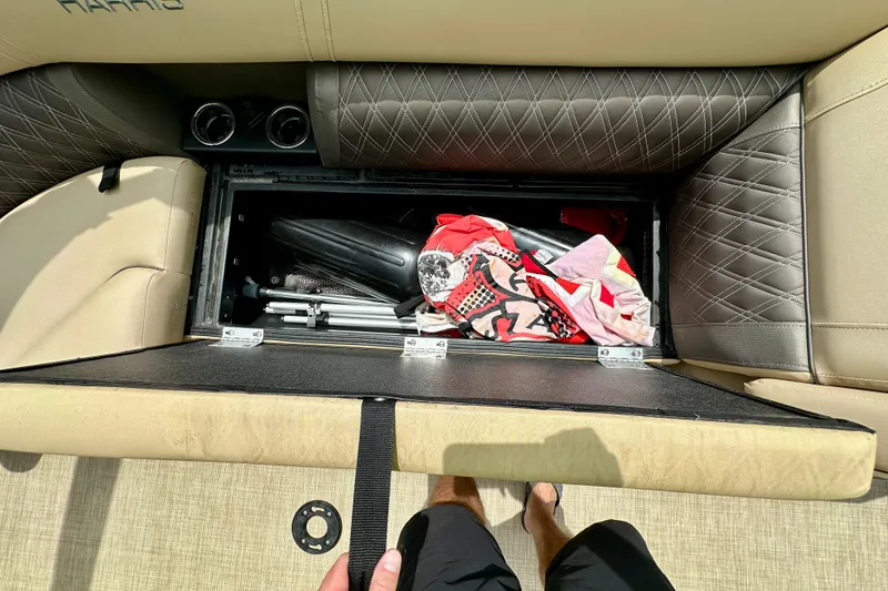 Slide: The Image of Storage compartment in 2022 Harris FloteBote 230 Super Sunliner LX with various items inside. - 37
