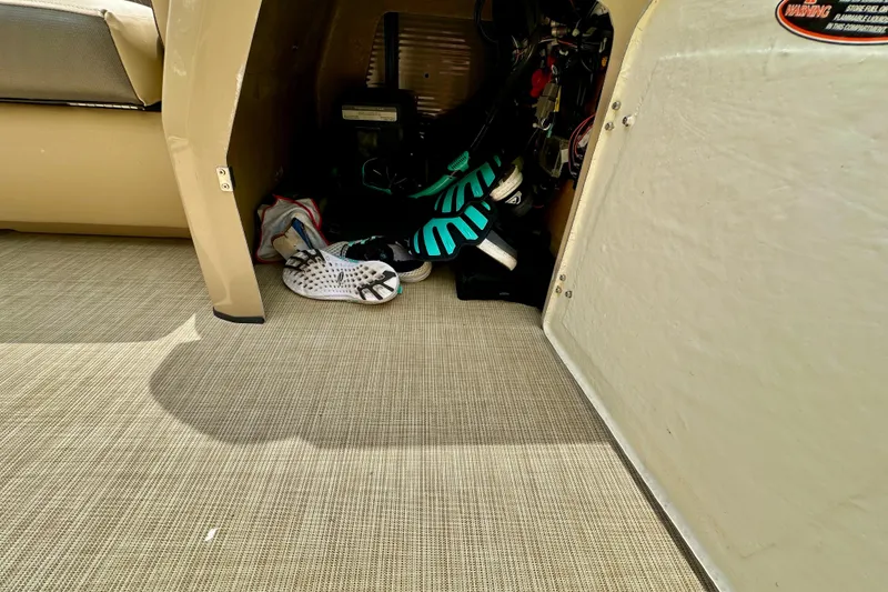 Slide: The Image of Storage compartment in 2022 Harris FloteBote 230 Super Sunliner LX with shoes and equipment. - 39