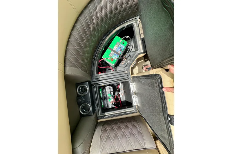 Slide: The Image of Open battery compartment in 2022 Harris FloteBote 230 Super Sunliner LX with quilted seating. - 40