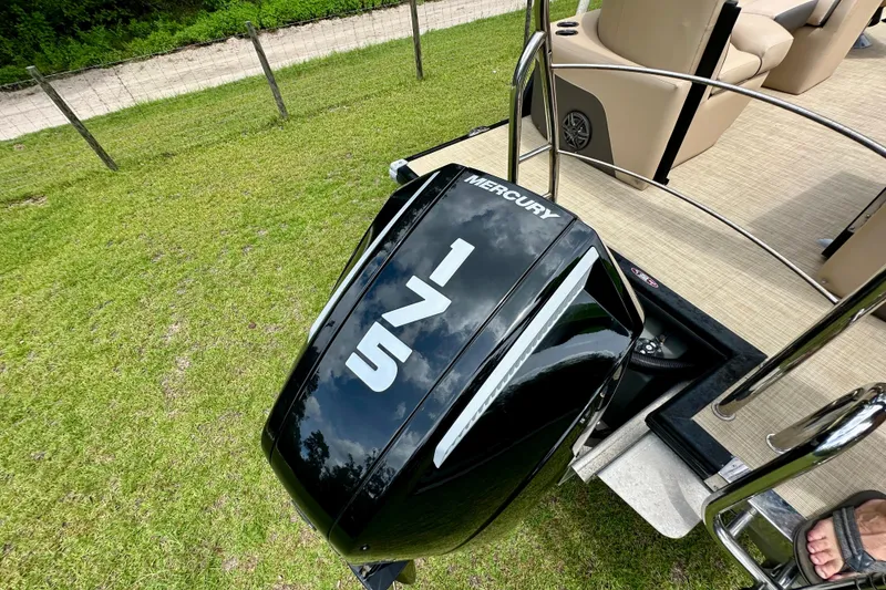 Slide: The Image of 2022 Harris FloteBote 230 Super Sunliner LX with Mercury outboard motor on grassy area. - 42