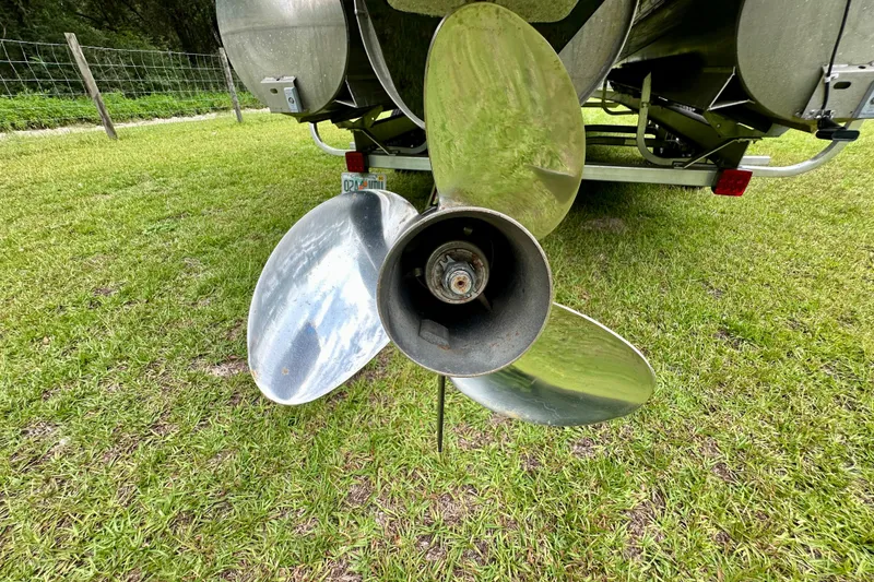 Slide: The Image of Propeller of 2022 Harris FloteBote 230 Super Sunliner LX on grassy field. - 45