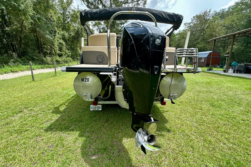 Slide: The Image of 2022 Harris FloteBote 230 Super Sunliner LX pontoon boat on grass, rear view. - 5