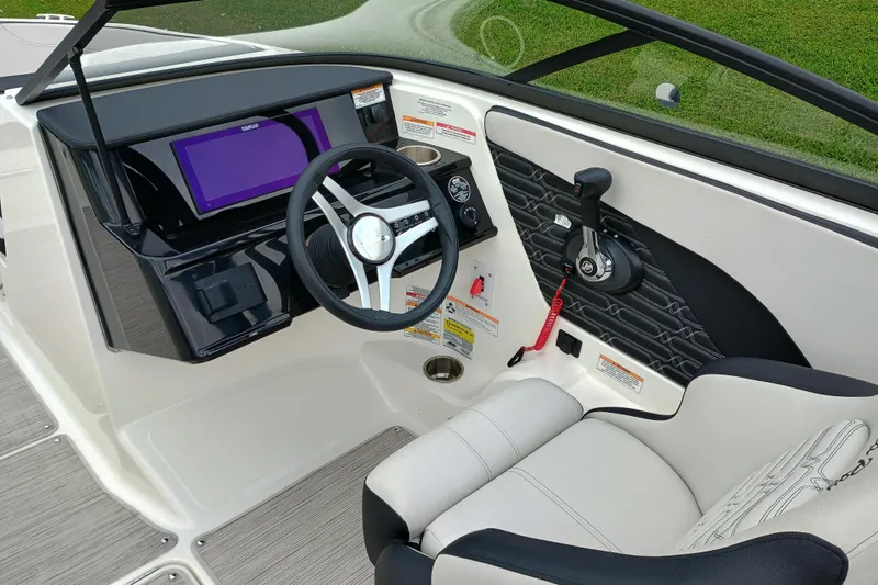 Slide: The Image of 2024 Sea Ray SPX 210 boat interior with steering wheel and control panel. - 3