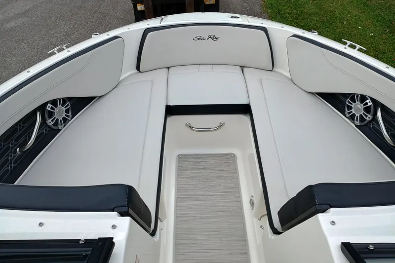Slide: The Image of 2024 Sea Ray SPX 210 boat interior with white seating and sleek design. - 4