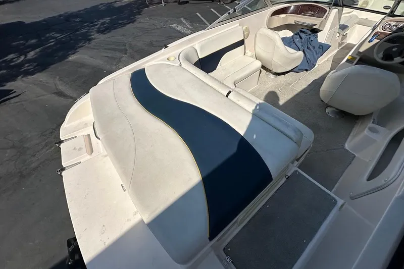 Slide: The Image of 2002 Rinker 212 Captiva boat interior with seating and dashboard view. - 10