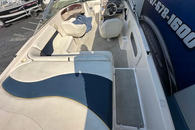 Slide: The Image of 2002 Rinker 212 Captiva boat interior with seating and steering wheel. - 11
