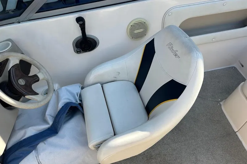 Slide: The Image of 2002 Rinker 212 Captiva boat interior with steering wheel and captain's seat. - 16