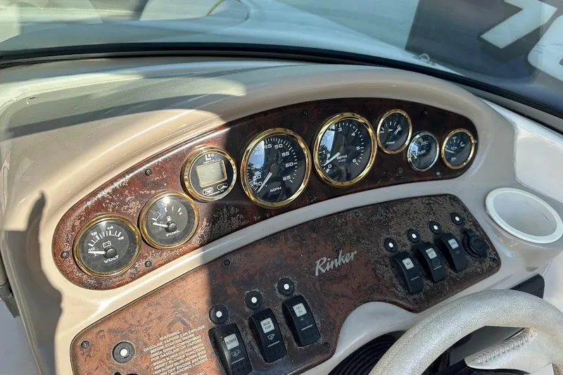Slide: The Image of Dashboard of a 2002 Rinker 212 Captiva boat with gauges and controls. - 18