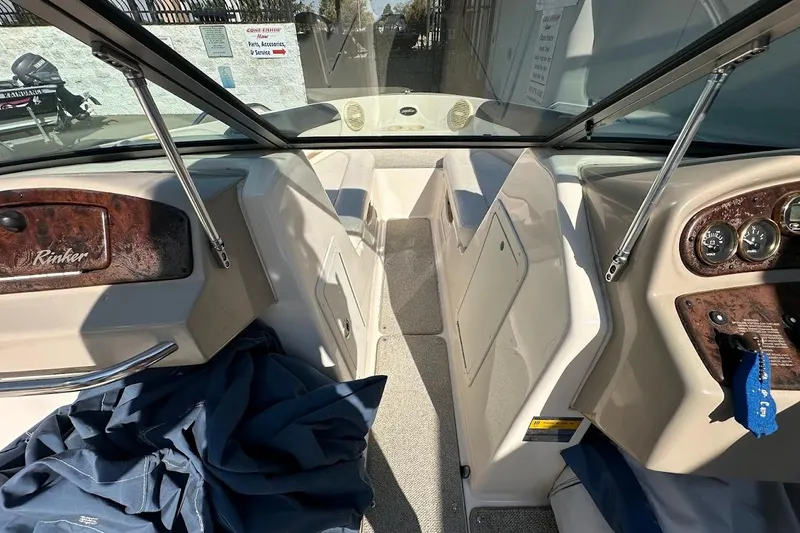 Slide: The Image of 2002 Rinker 212 Captiva boat interior with dashboard and seating area. - 19