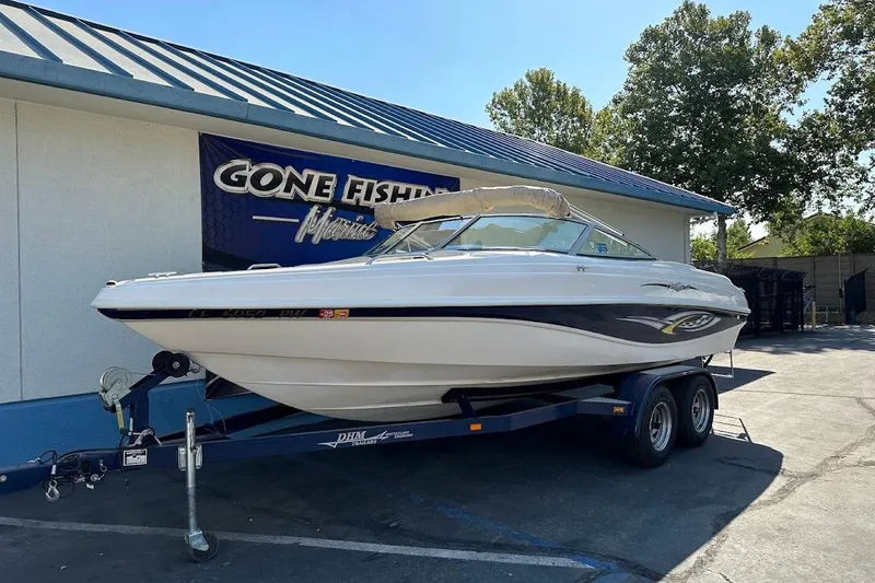 Slide: The Image of 2002 Rinker 212 Captiva boat on trailer at Gone Fishin' Marine dealership. - 2