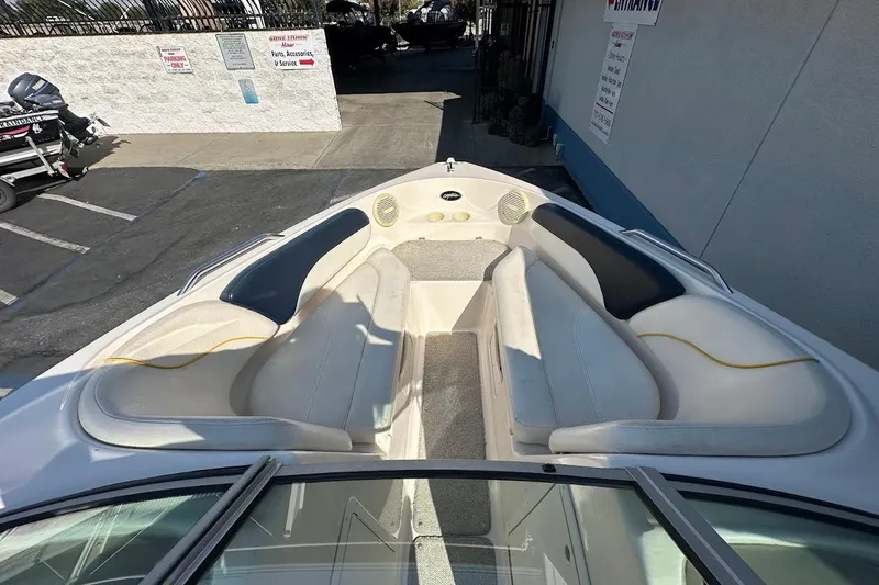 Slide: The Image of 2002 Rinker 212 Captiva boat interior with white seating and gray carpet. - 20