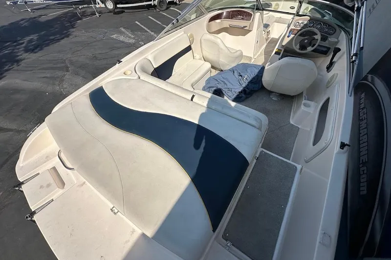Slide: The Image of 2002 Rinker 212 Captiva boat interior with seating and steering wheel. - 9