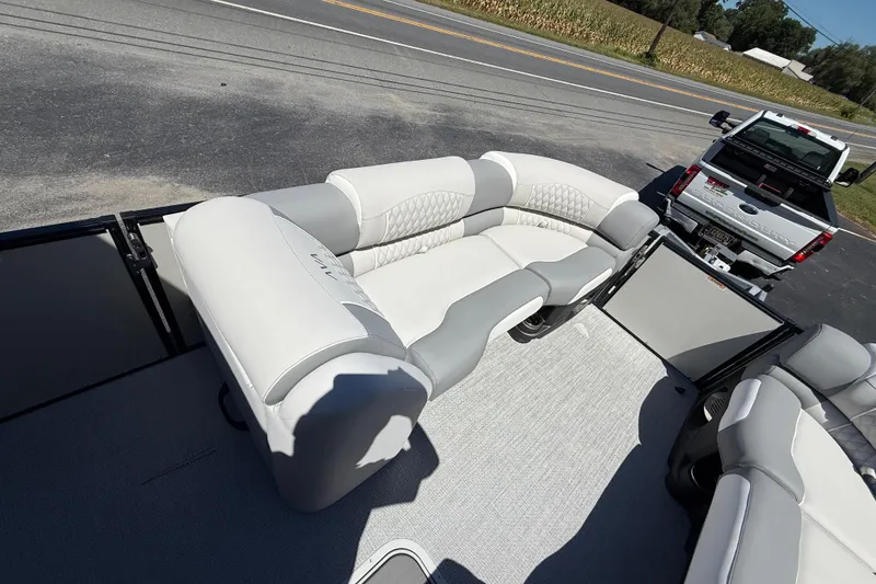 Slide: The Image of Luxurious seating on 2026 Avalon 2585 Excalibur LTD pontoon boat, parked near a road. - 16