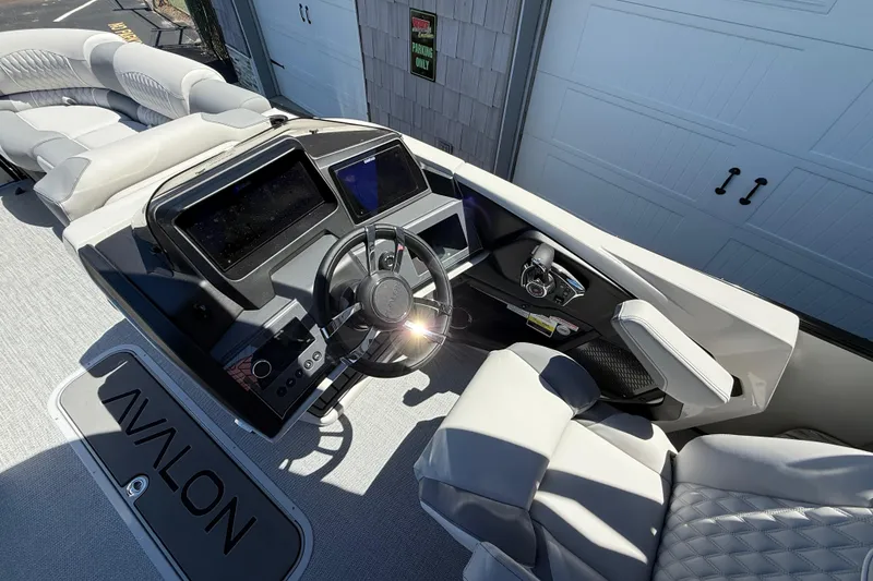 Slide: The Image of 2026 Avalon 2585 Excalibur LTD boat interior with modern dashboard and steering wheel. - 21