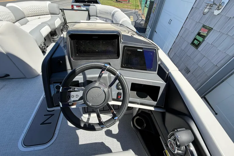 Slide: The Image of Interior of 2026 Avalon 2585 Excalibur LTD boat with modern dashboard and steering wheel. - 22