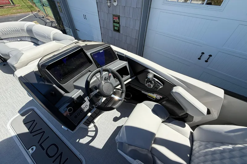 Slide: The Image of 2026 Avalon 2585 Excalibur LTD boat interior with modern dashboard and luxurious seating. - 23