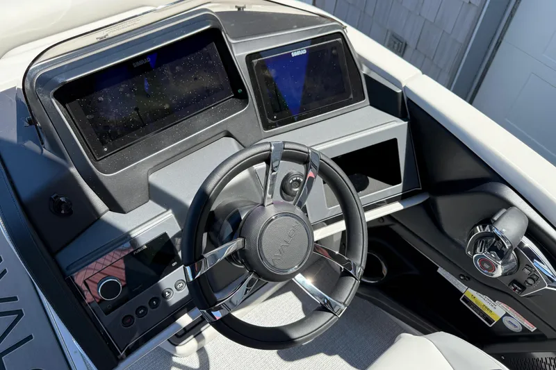 Slide: The Image of 2026 Avalon 2585 Excalibur LTD boat dashboard with steering wheel and advanced controls. - 29