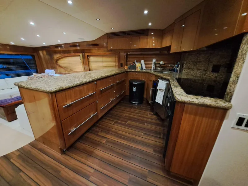 Slide: The Image of Luxurious kitchen in 2006 Hatteras 68 Convertible yacht with granite countertops and wood flooring. - 17