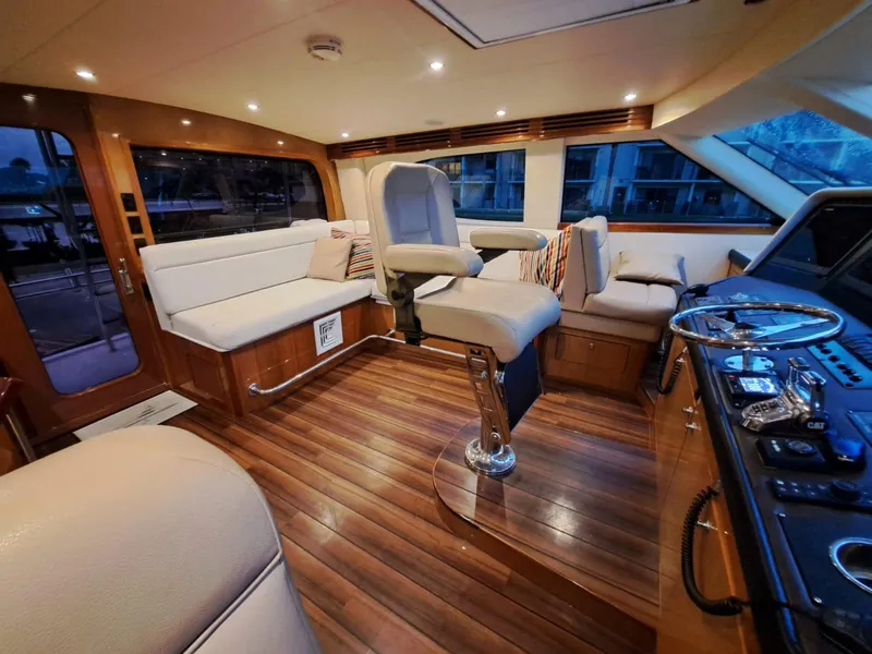 Slide: The Image of Luxurious interior of 2006 Hatteras 68 Convertible yacht with elegant wood finishes. - 19