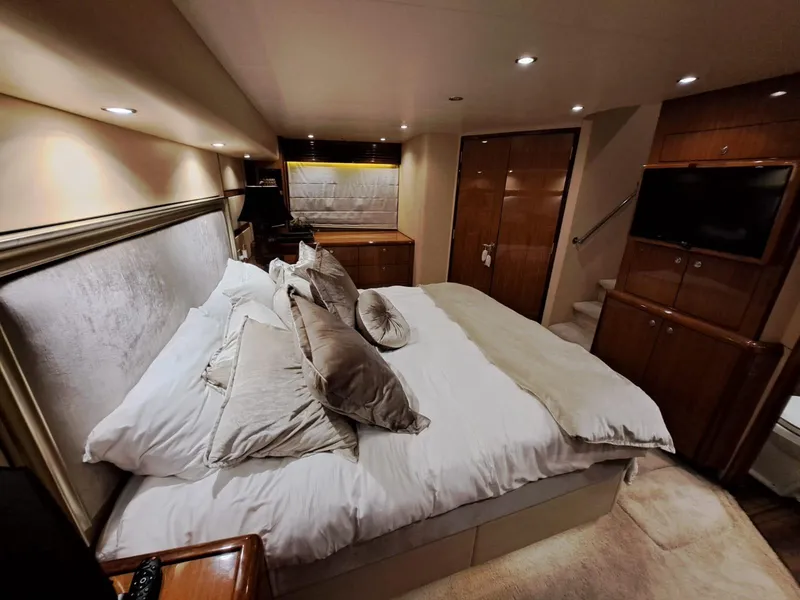 Slide: The Image of Luxurious bedroom interior of 2006 Hatteras 68 Convertible yacht with elegant decor. - 24