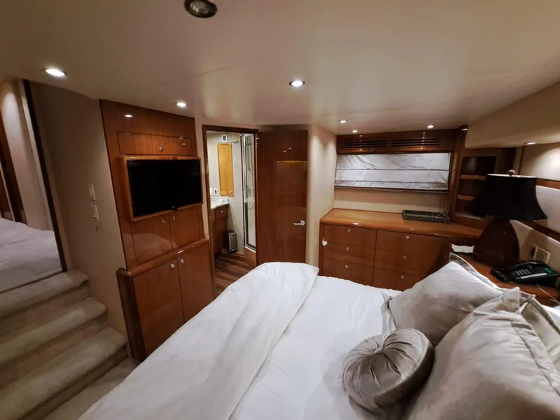 Slide: The Image of Luxurious bedroom interior of 2006 Hatteras 68 Convertible yacht with wood finishes and modern amenities. - 27