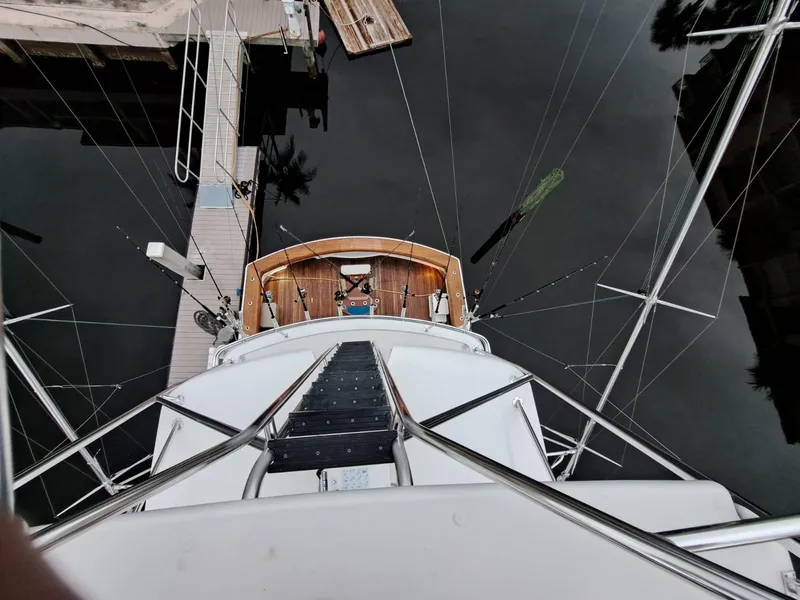 Slide: The Image of Luxurious 2006 Hatteras 68 Convertible yacht with elegant teak deck and serene waterfront view. - 40