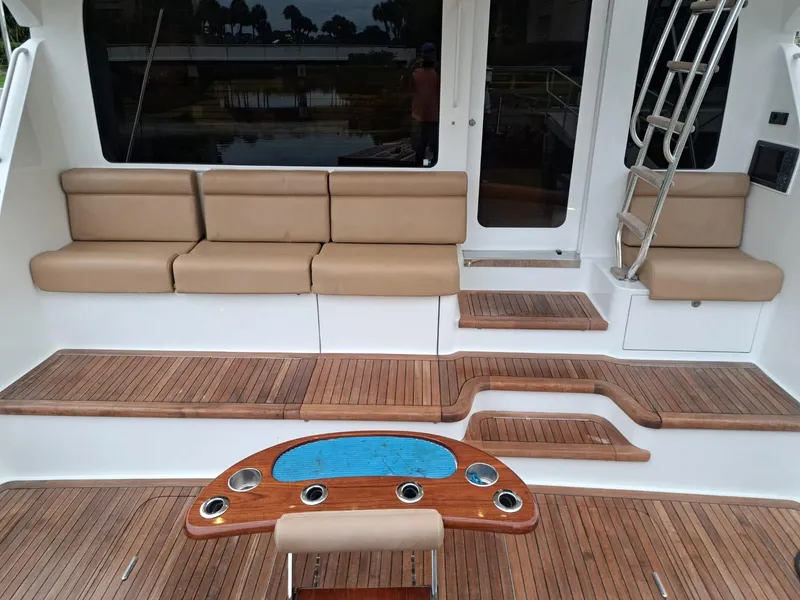 Slide: The Image of 2006 Hatteras 68 Convertible yacht with spacious teak deck and seating area. - 5