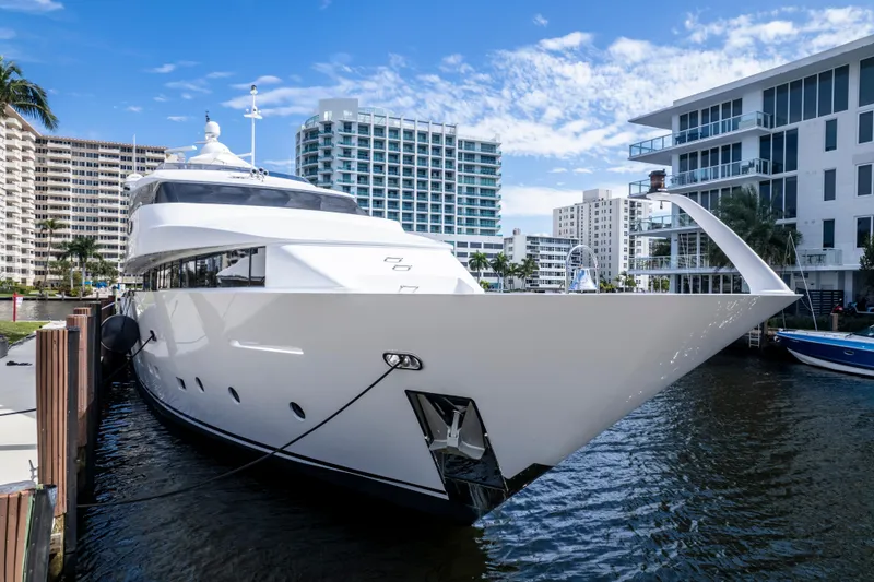 Slide: The Image of Luxurious 1998 Intermarine 118 yacht docked in a modern marina setting. - 14
