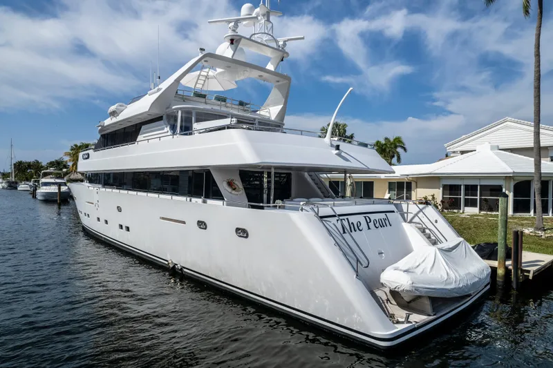 Slide: The Image of Luxury 1998 Intermarine 118 yacht docked, named "The Pearl," under a clear blue sky. - 3