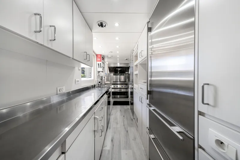 Slide: The Image of Modern yacht kitchen with stainless steel appliances, sleek cabinetry, and bright lighting. Intermarine 118, 1998. - 33