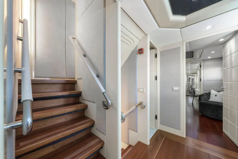 Slide: The Image of Luxurious interior of 1998 Intermarine 118 yacht with elegant wooden staircase and modern design. - 37