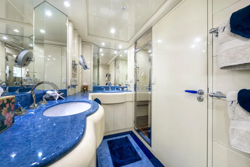 Slide: The Image of Luxurious yacht bathroom with blue countertops, mirrors, and towels, Intermarine 118, 1998 model. - 44