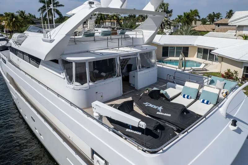 Slide: The Image of Luxury 1998 Intermarine 118 yacht with spacious deck and jet skis docked at marina. - 5