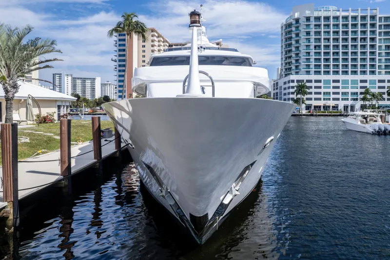 Slide: The Image of Luxury 1998 Intermarine 118 yacht docked in a marina, surrounded by modern buildings. - 6