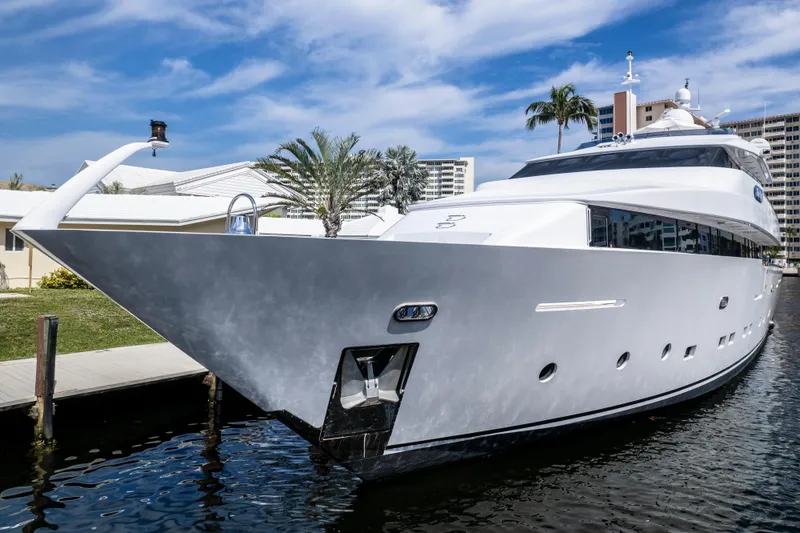 Slide: The Image of Luxurious 1998 Intermarine 118 yacht docked by palm trees and buildings. - 8